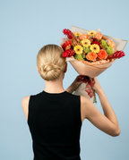 Coral Sunset Bouquet held by model — editorial